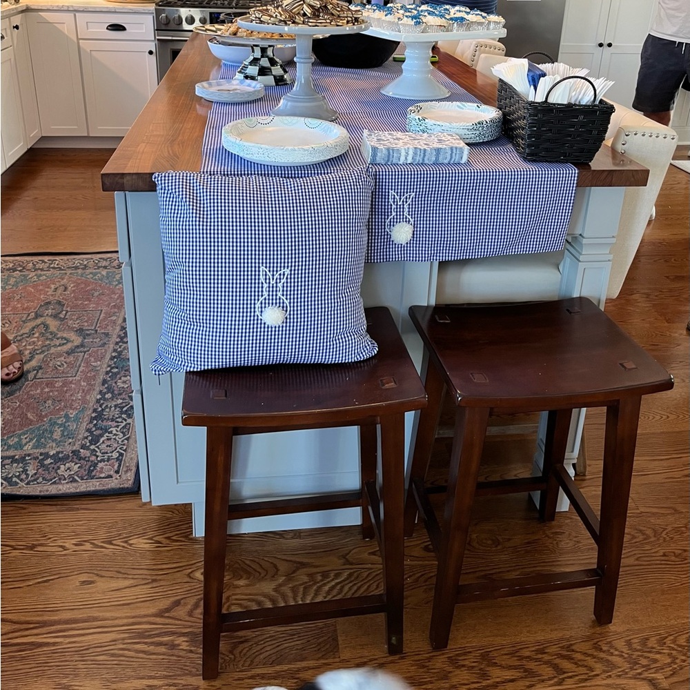Two blue gingham table runners with embroidered bunnies at each end